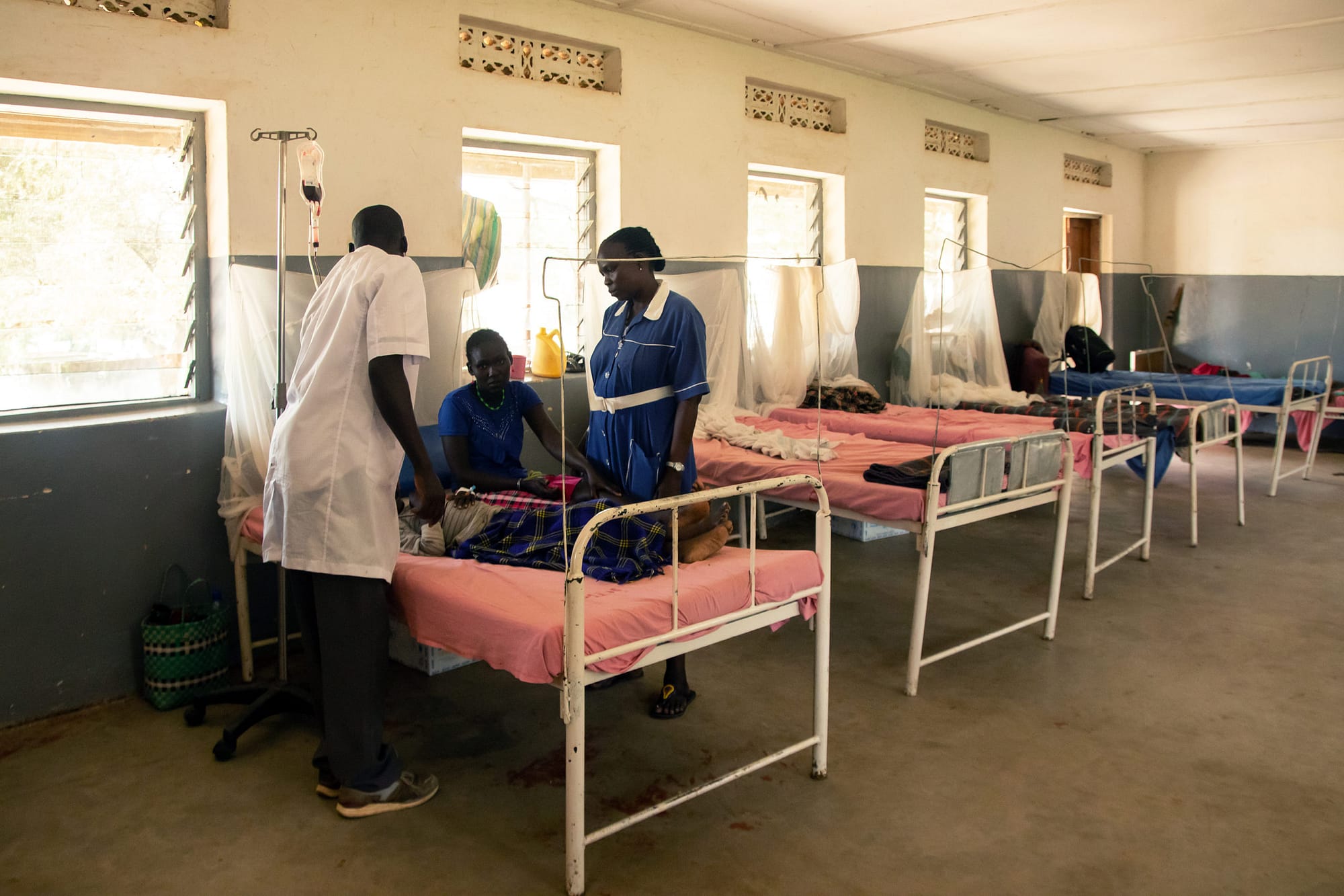 Healthcare workers with patients in a hospital ward