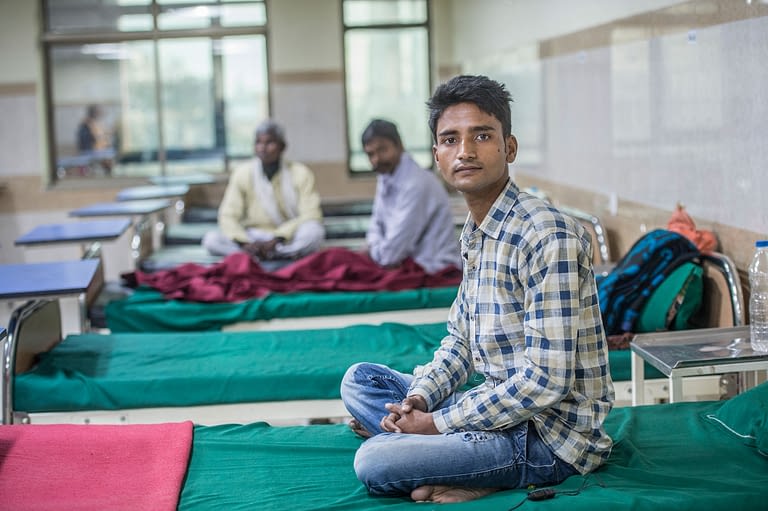 Boy sitting on a hospital bed