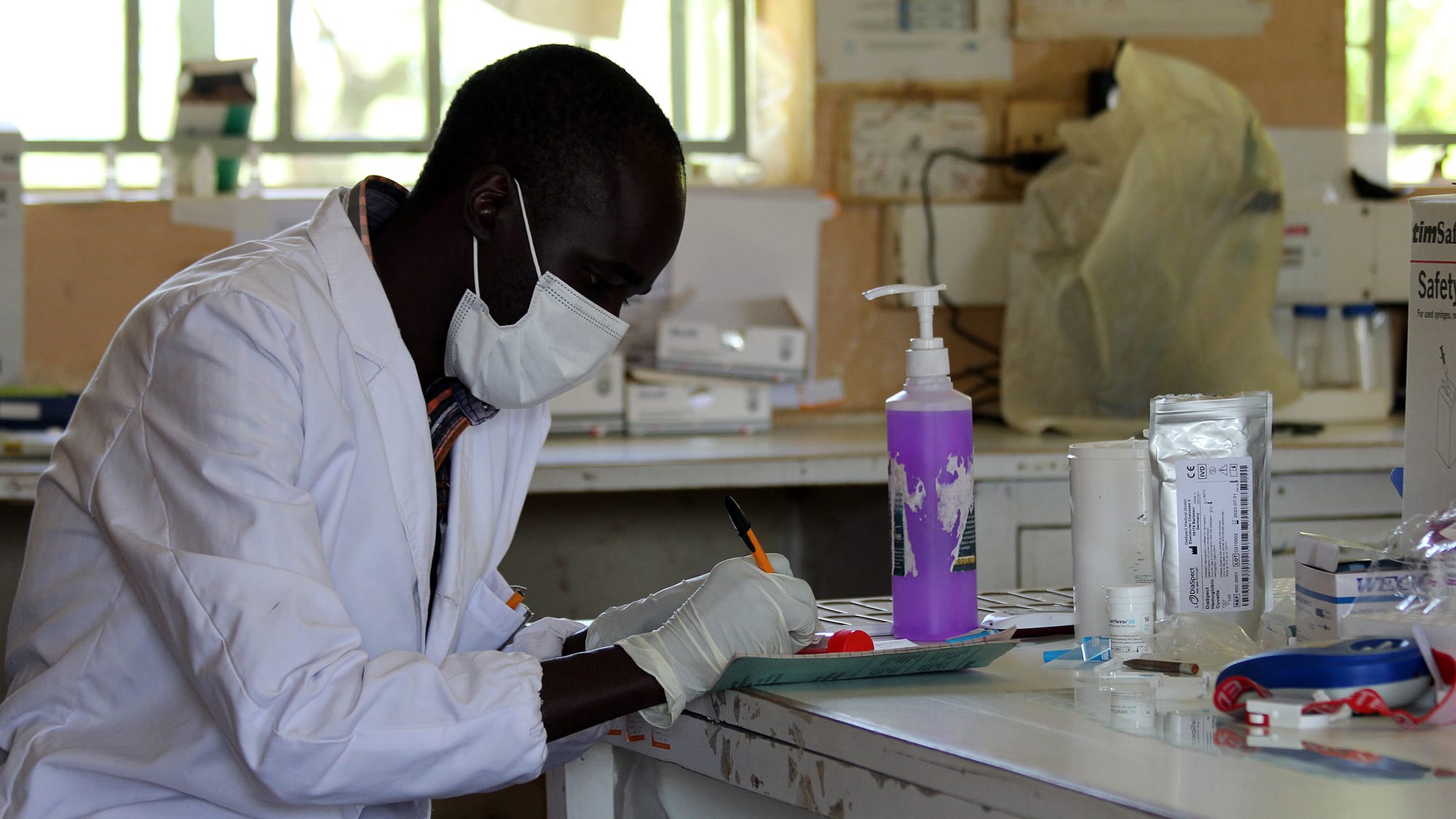 Lab Technologist at the Kacheliba Sub-County Hospital labelling a sample