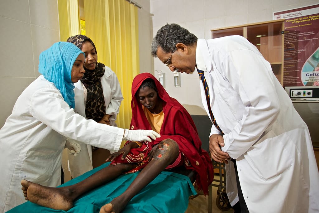 Mycetoma patient being examined by healthcare workers at the MRC in Sudan