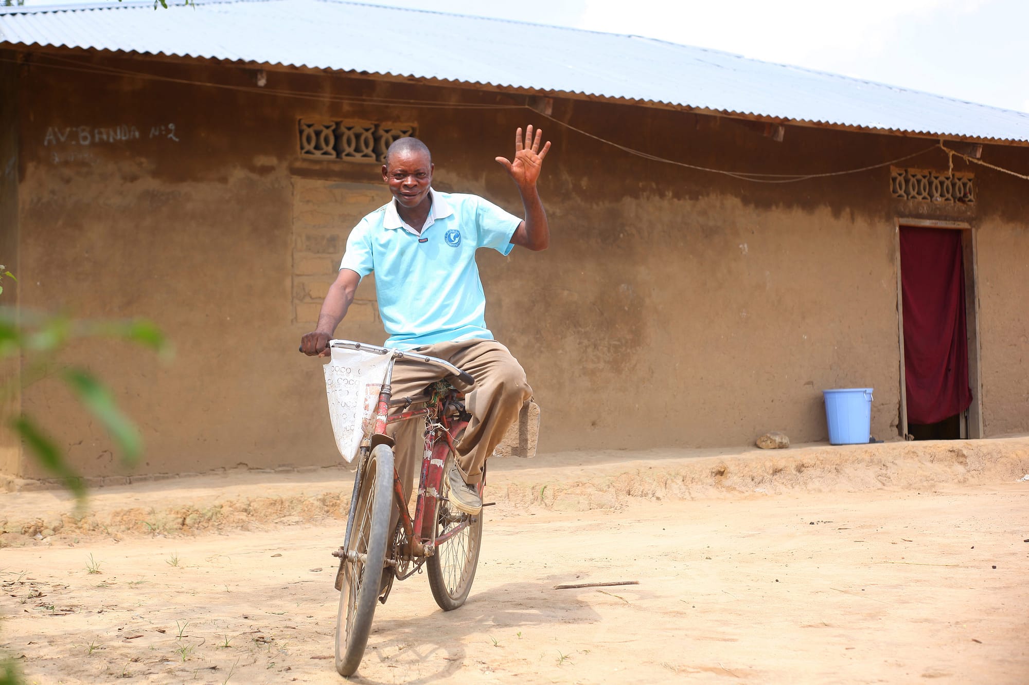 Man riding a bike in rural village