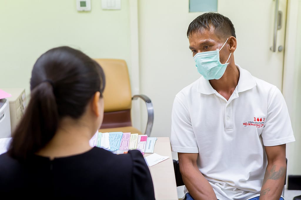 Male hep C patient discussing with medical staff