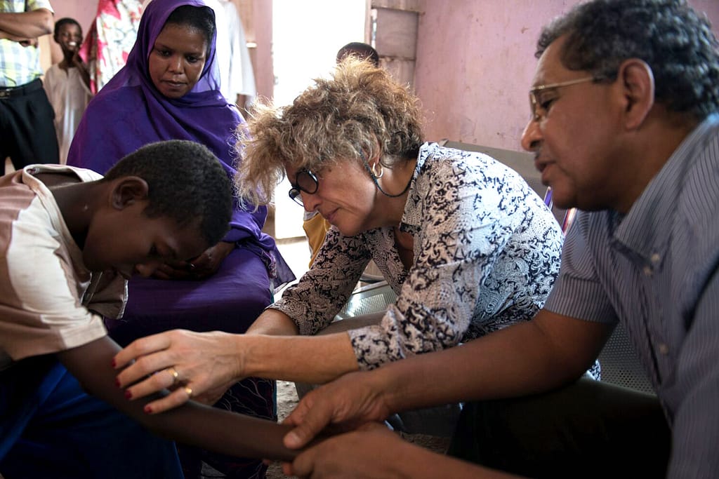 Dr Nathalie Strub-Wourgaft examines patient in Sudan.