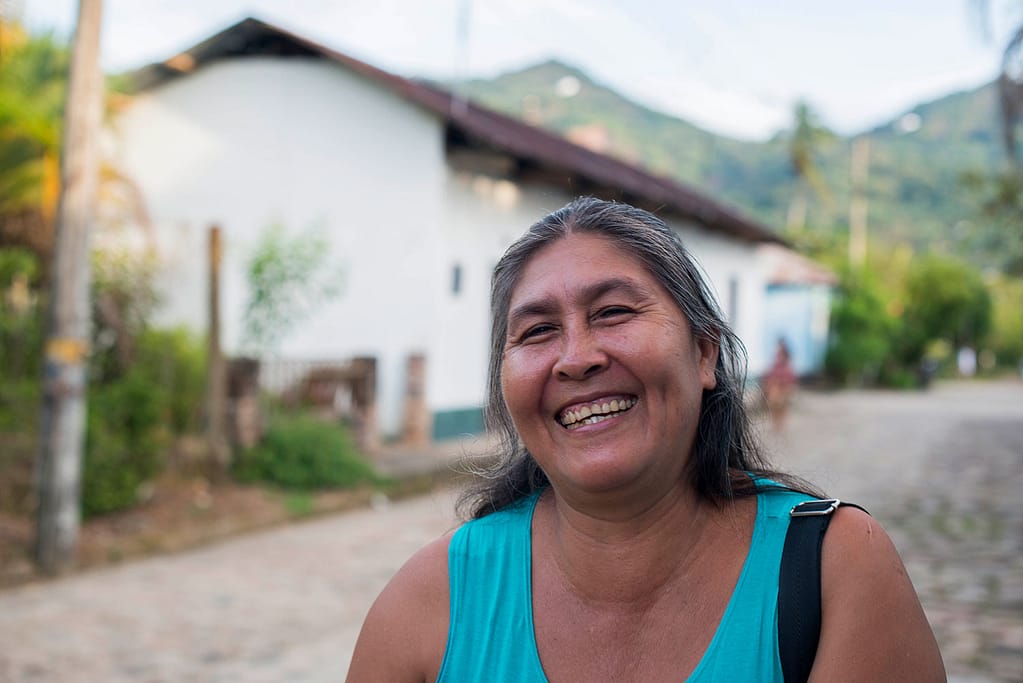 Woman with Chagas disease smiling in a street of Colombia