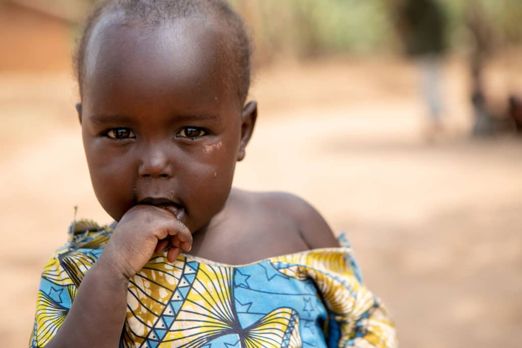 Young child looking at the camera in village in Uganda