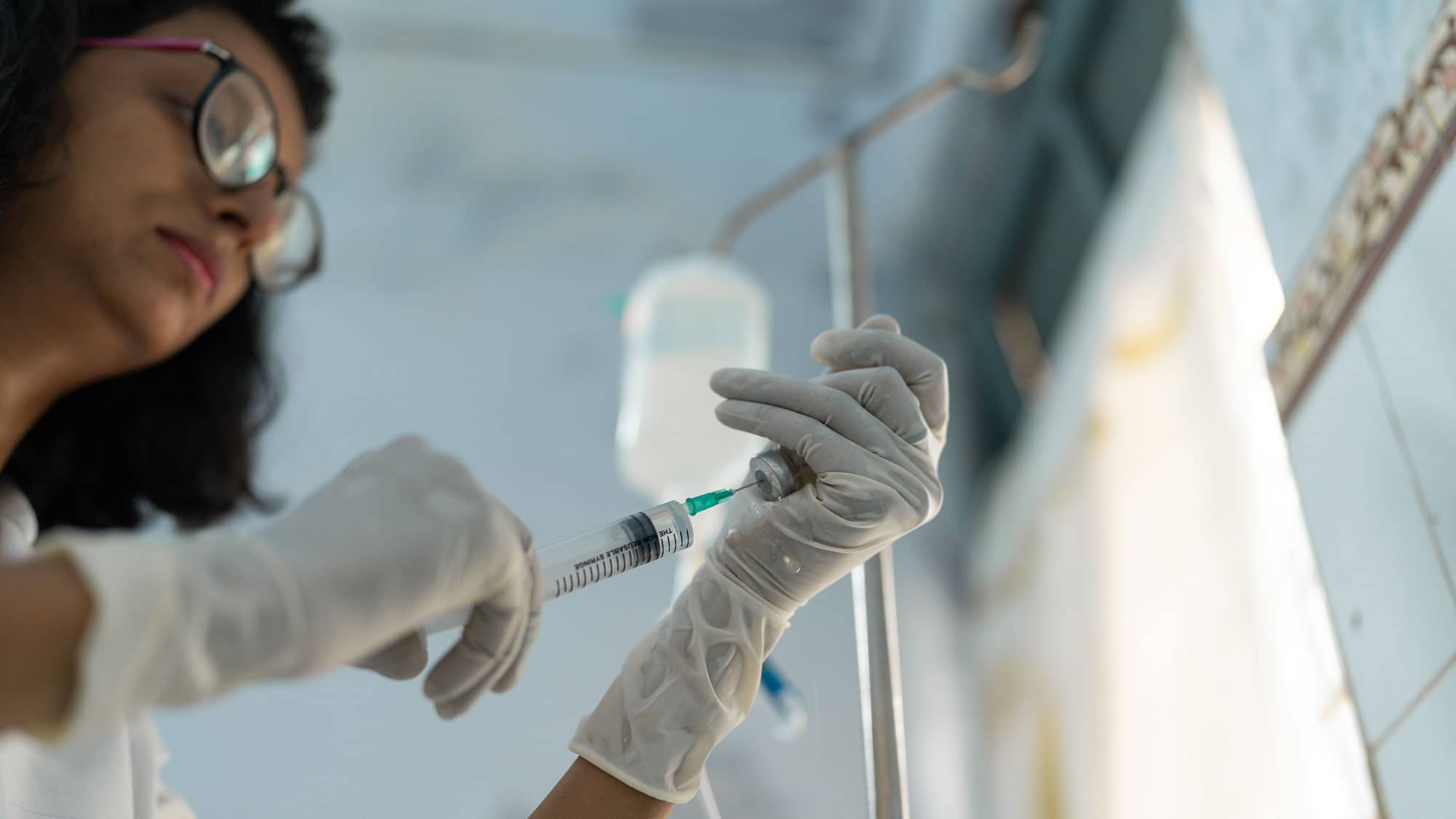 Healthcare worker handling needle