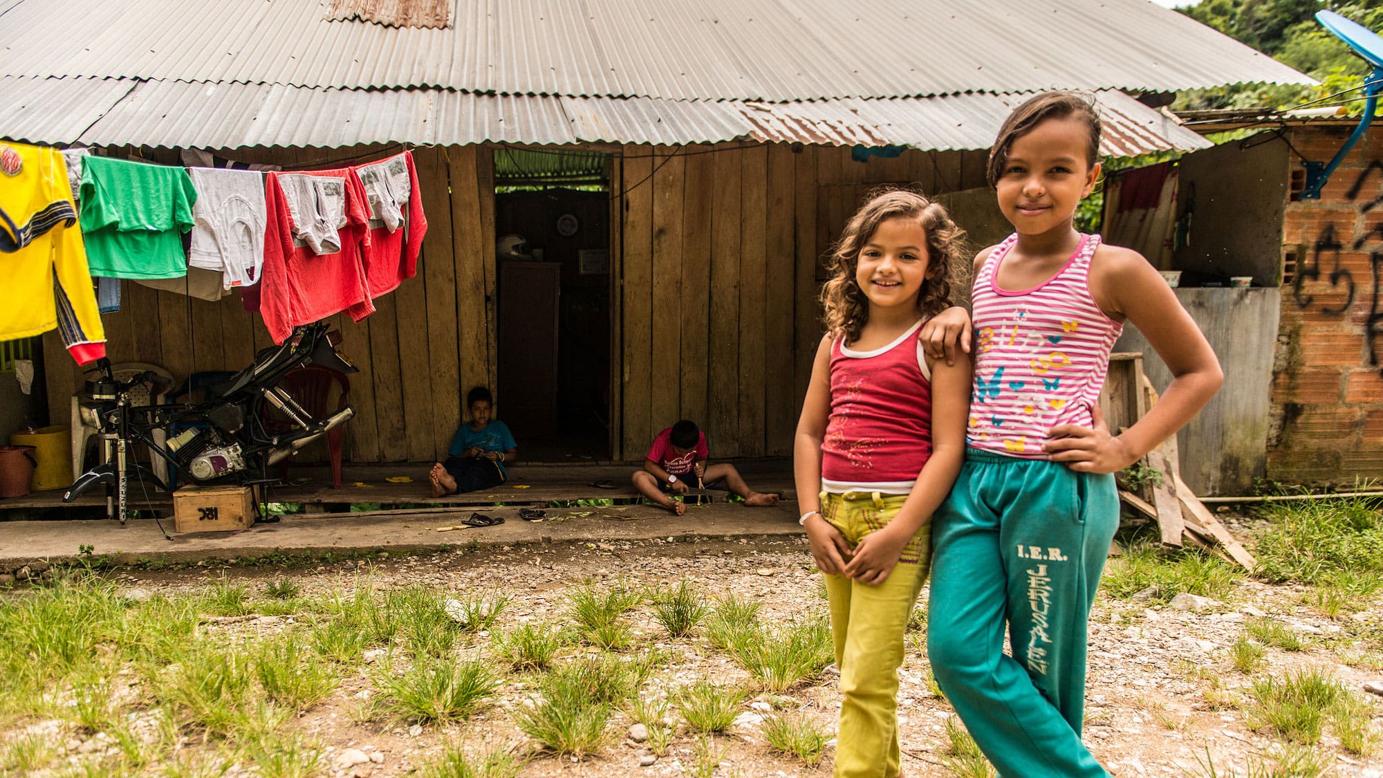 Children standing in front of a house in rural village in Colombia