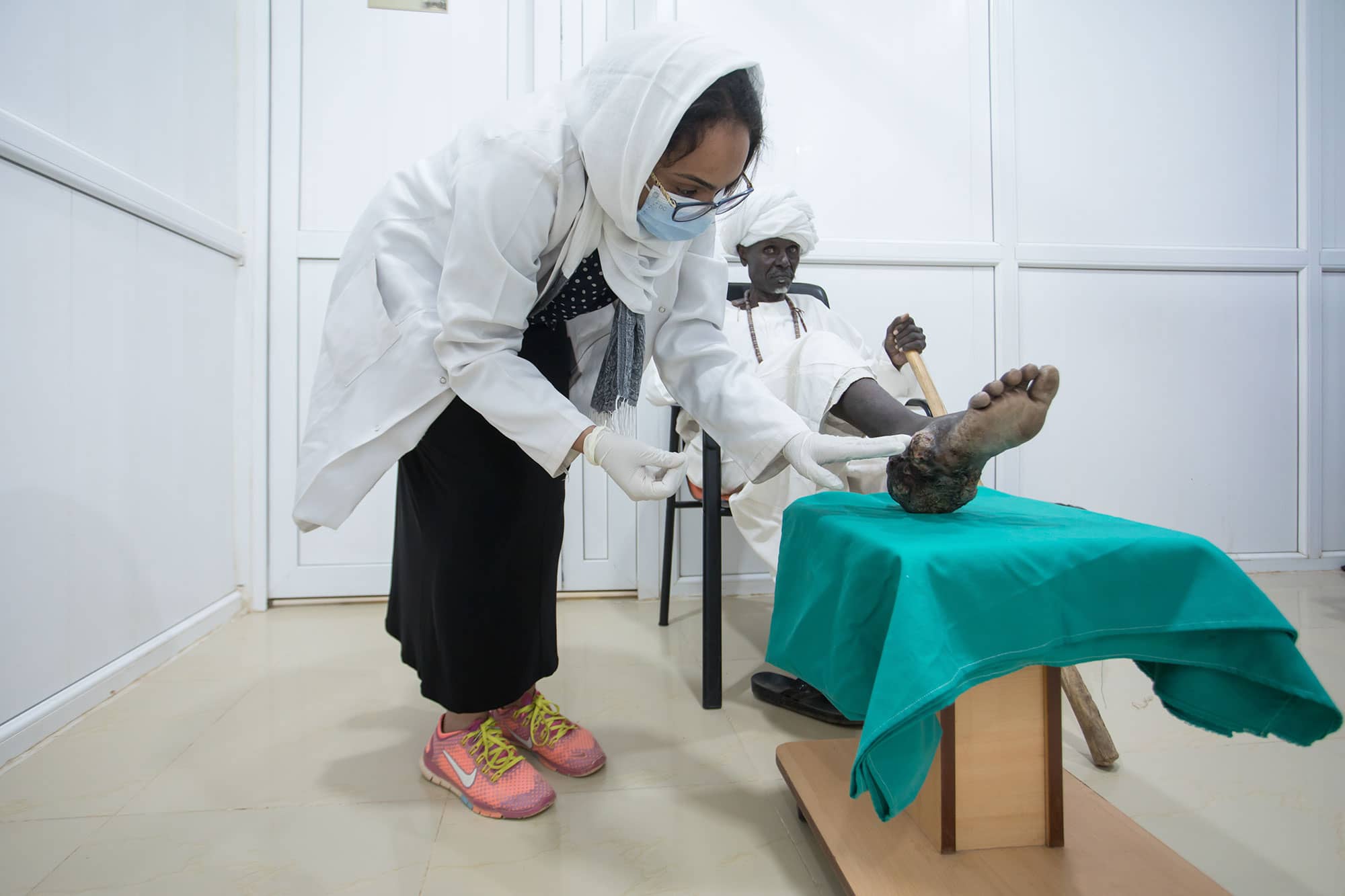 Nurse caring for patient with a lesion on the feet