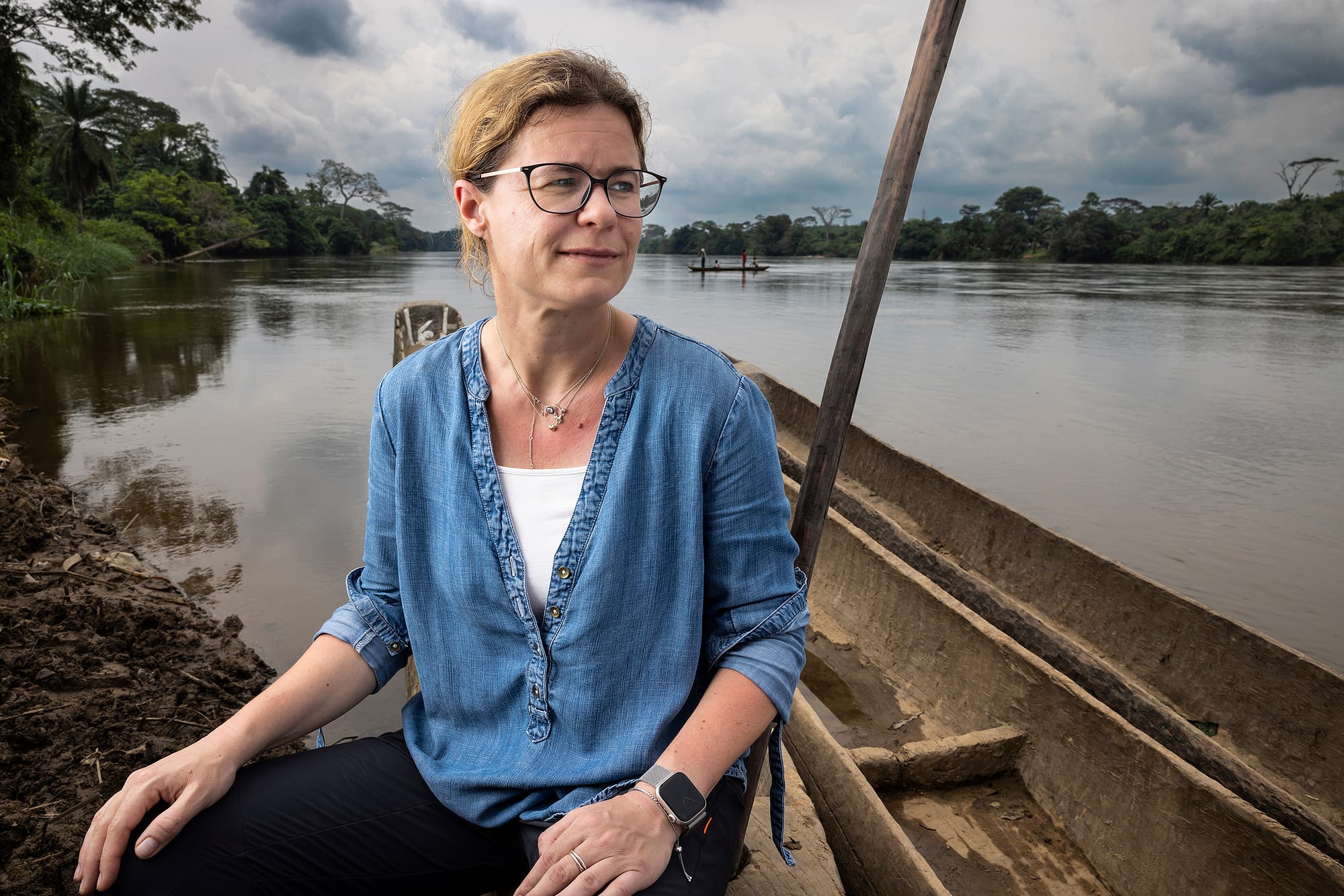 Sabine Specht, our Head of Filarial Diseases, sitting by a river