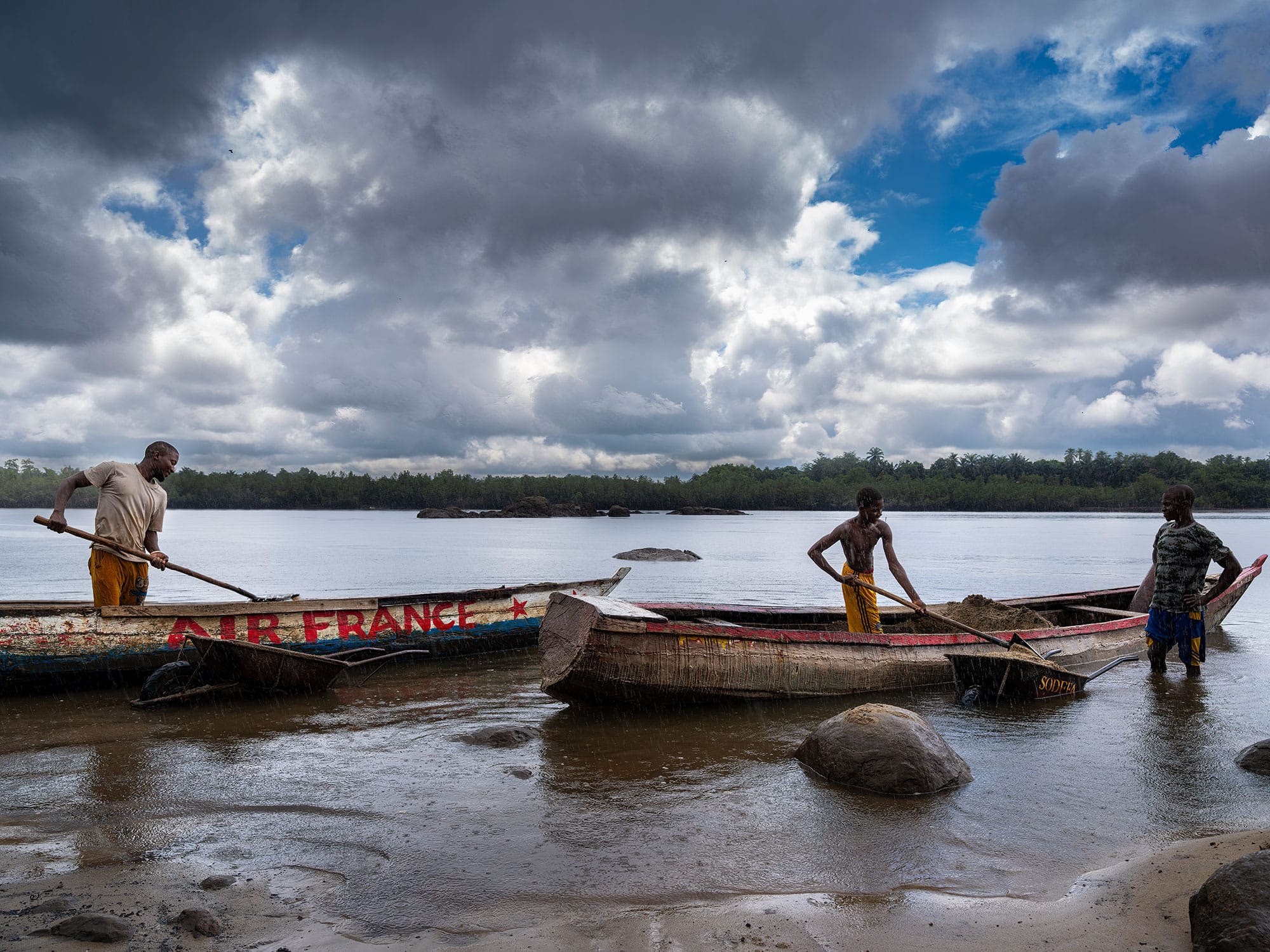 Fishermen in canoes on the river