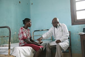 Doctor giving fexinidazole to a patient